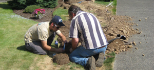 two Colleyville irrigation repair techs are working on a new system installation